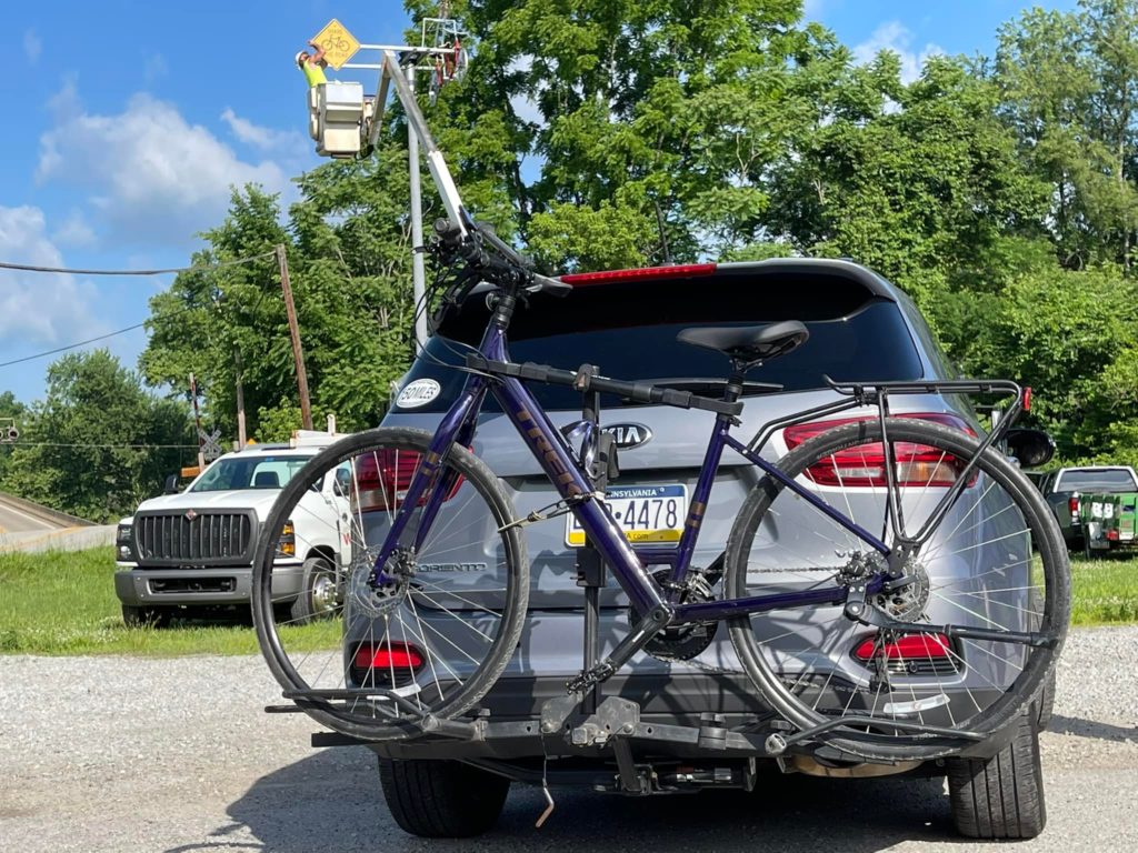 A bicycle on the back of a car.