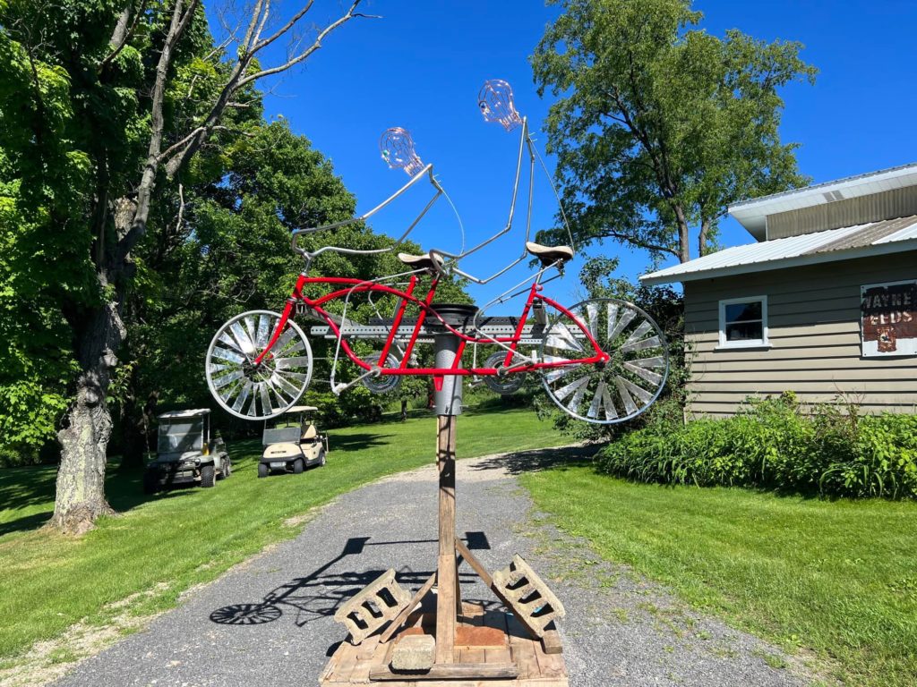 Part of the art installation, a red two seat bicycle.